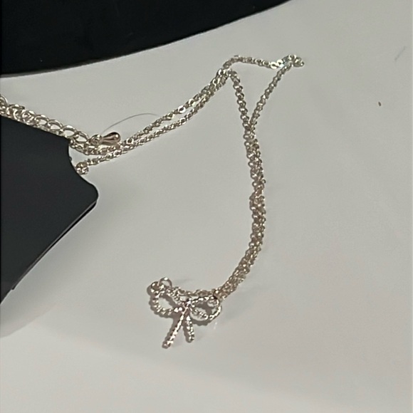 Jewelry - Silvertone bow necklace new